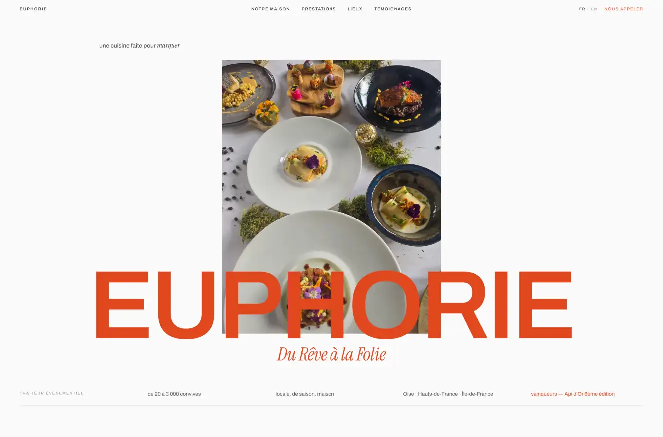 An event caterer website: the name in orange capitals over a top-down photograph of plated dishes.